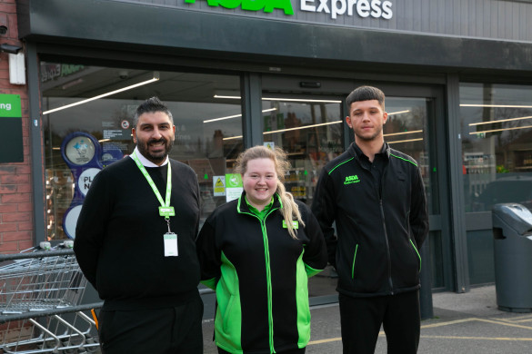 Three colleagues smiling outside Asda Express