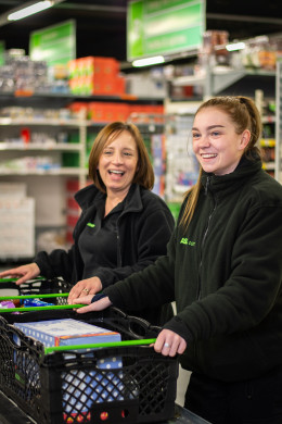 Colleagues filling up customer delivery baskets