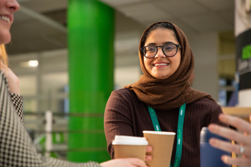 Colleagues at Cafe Quays chatting over coffees