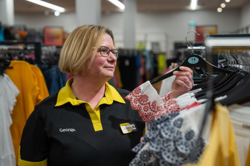 George colleague restocking clothing rails