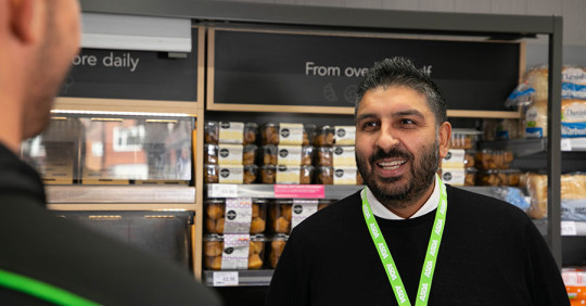 Asda Express colleagues chatting in aisle