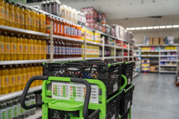 Trolley in drinks aisle of store