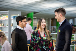 Colleagues chatting in kitchen area of Asda house